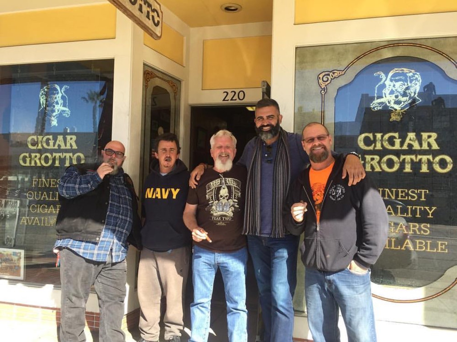 A group of regulars enjoying cigars outside Cigar Grotto